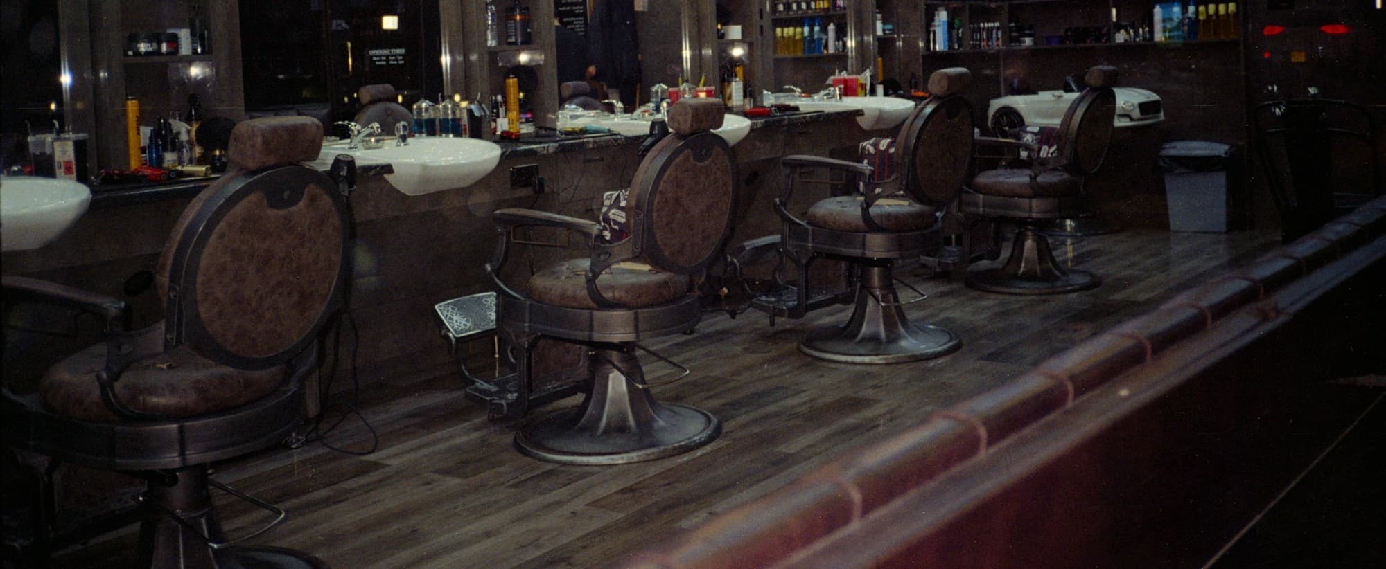 The shop floor — a row of vintage barber chairs